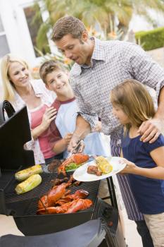 Royalty Free Photo of a Family Barbecuing