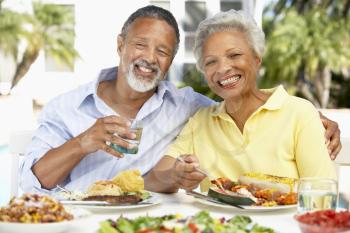 Royalty Free Photo of a Couple Eating Outside