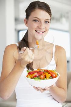 Royalty Free Photo of a Girl Eating Salad
