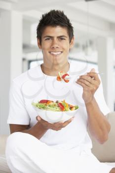 Royalty Free Photo of a Guy Eating Salad