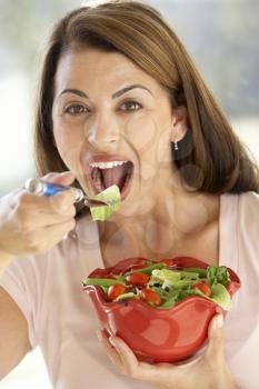 Royalty Free Photo of a Woman Eating Salad