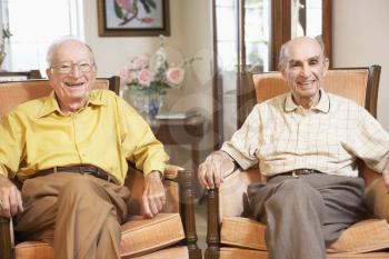 Royalty Free Photo of Two Men Relaxing in Armchairs