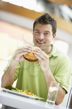 Royalty Free Photo of a Man Eating Lunch at a Cafe