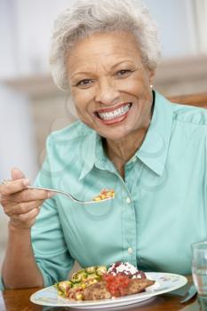 Royalty Free Photo of a Woman Enjoying a Meal