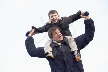 Royalty Free Photo of a Man With His Son on His Shoulders