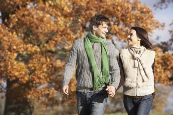 Royalty Free Photo of a Young Couple Walking in the Park