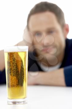 Royalty Free Photo of a Man Looking at a Glass of Beer