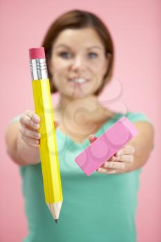 Royalty Free Photo of a Woman With a Big Eraser and Pencil