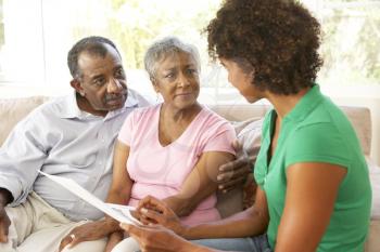 Royalty Free Photo of a Woman With an Older Couple Looking at Papers