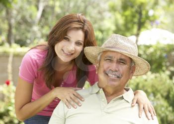 Senior Man With Adult Daughter In Garden