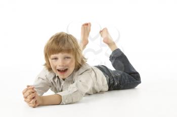 Young Boy Lying On Stomach In Studio