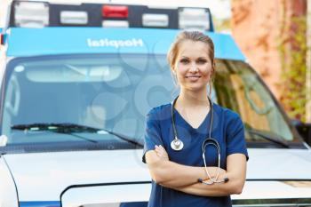 Portrait Of Female Doctor Standing In Front Of Ambulance