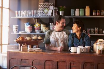 Couple Running Coffee Shop Behind Counter