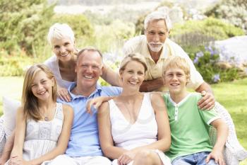 Extended Family Relaxing In Garden