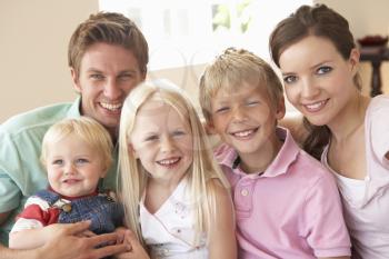 Family Sitting On Sofa At Home Together