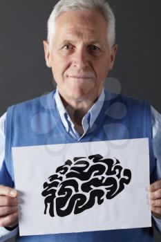 Senior man holding ink drawing of brain