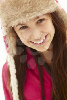 Portrait Of Teenage Girl In Snow Wearing Fur Hat