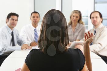 View From Behind As CEO Addresses Meeting In Boardroom