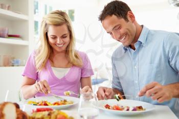 Couple Eating Meal At Home Together