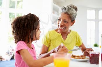 Grandmother And Granddaughter Having Breakfast Together