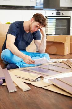 Frustrated Man Putting Together Self Assembly Furniture