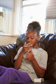 Girl Discovering Parent's Pack Of Cigarettes At Home