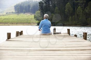 Senior man fishing on jetty