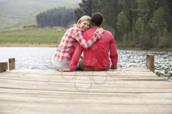 Romantic couple sitting on a jetty