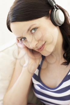 Woman listening to music through headphones