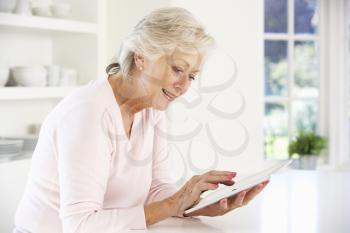 Senior woman using tablet at home