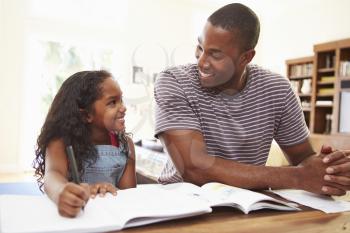 Father Helping Daughter With Homework