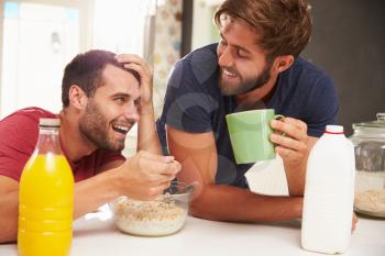 Two Male Friends Enjoying Breakfast At Home Together