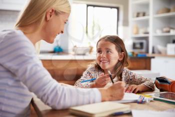 Mother teaching her daughter at home