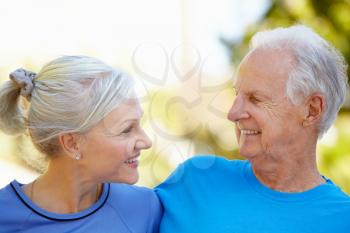 Elderly man and younger woman outdoors