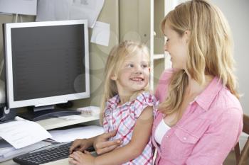 Mother And Daughter Together In Home Office