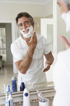 Man Shaving In Bathroom Mirror