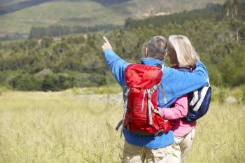 Senior Couple On Hike Through Beautiful Countryside