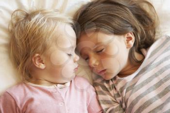 Two Young Girls Sleeping In Bed
