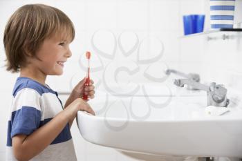 Boy In Bathroom Brushing Teeth