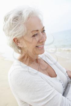 Senior Woman Standing On Beach