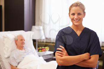 Portrait Of Nurse With Senior Male Patient In Hospital Bed