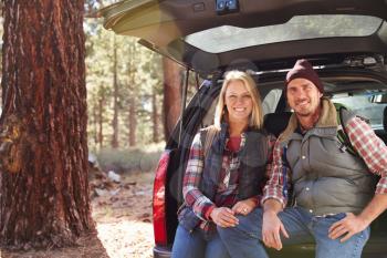 Portrait of a couple by their car before hiking, copy space