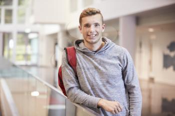 Young adult male student in the lobby of a university