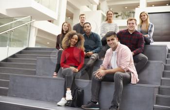 Portrait Of Student Group On Steps Of Campus Building