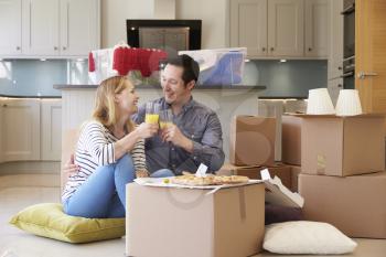 Couple Celebrating Moving Into New Home With Pizza