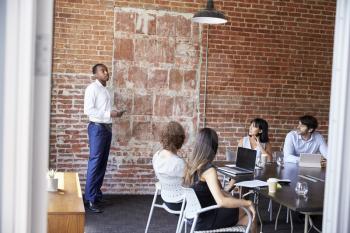 Businessman Standing To Address Boardroom Meeting