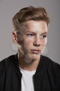 White teenage boy looking away, head and shoulders, vertical