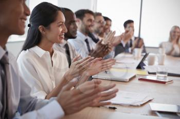 Businesspeople Around Boardroom Table Applaud Presentation