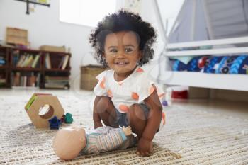 Cute Baby Girl Having Fun In Playroom With Toys