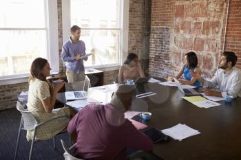 Businessman Standing To Address Boardroom Meeting